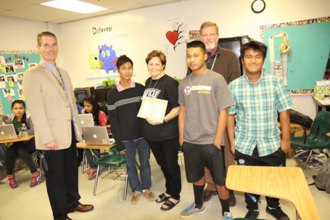 Mrs. Towe is presented with her Golden Apple Award in her classroom.