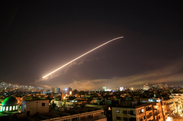 The Damascus sky lights up missile fire as the U.S. launches an attack on Syria targeting different parts of the capital early Saturday, April 14, 2018. Syrias capital has been rocked by loud explosions that lit up the sky with heavy smoke as U.S. President Donald Trump announced airstrikes in retaliation for the countrys alleged use of chemical weapons. (AP Photo/Hassan Ammar)